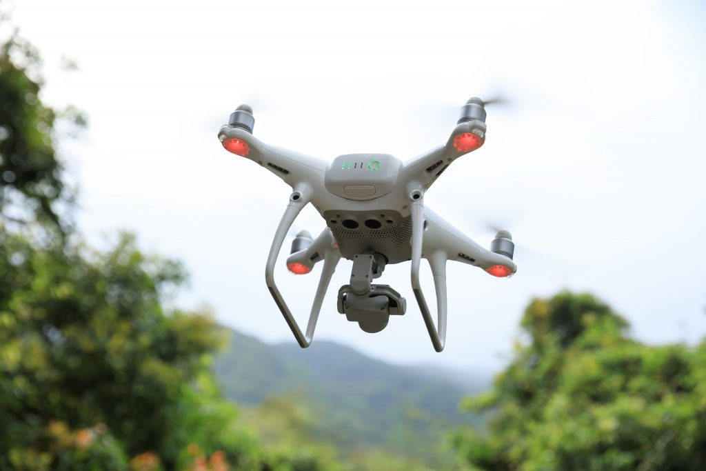 Drone with camera flying in tropical forest