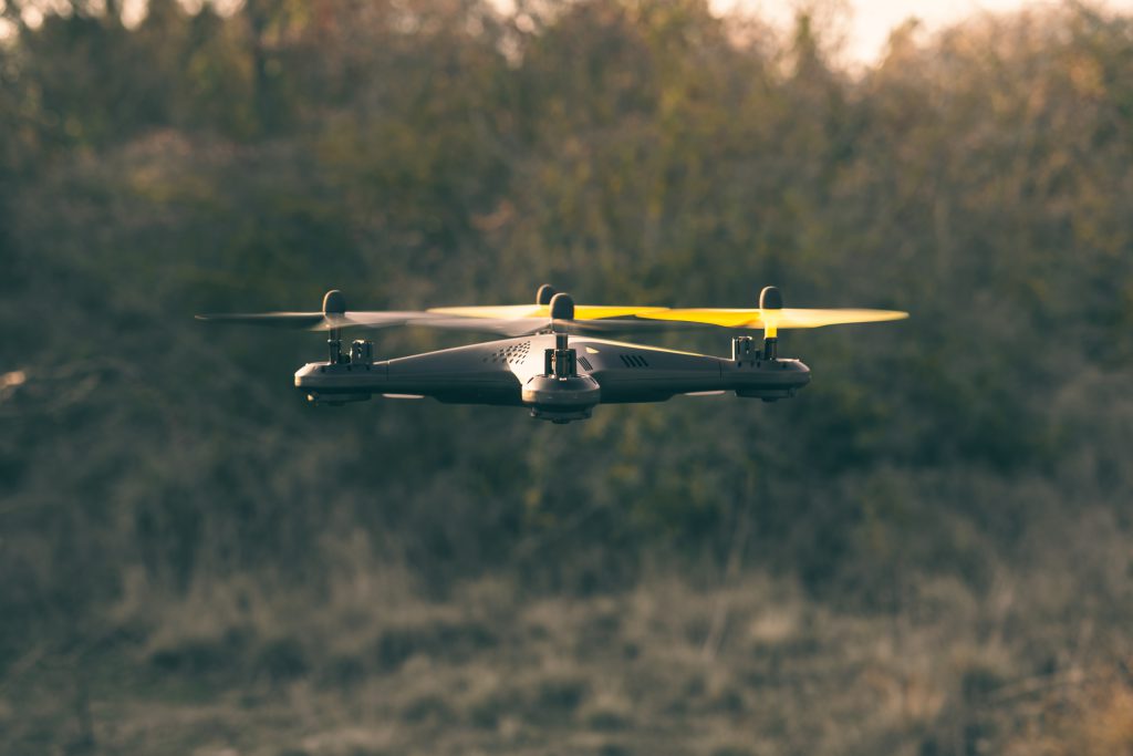 Flying drone in the background of the forest